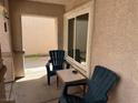 Cozy outdoor seating area with two chairs and a small table, enclosed for privacy and relaxation at 9611 Sky Hollow Dr, Las Vegas, NV 89123