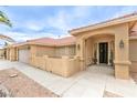 Inviting front entrance with arched entryway, mature landscaping, and a charming aesthetic at , Pahrump, NV 89061