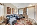 Comfortable living room with a grey sofa, stylish decor, and a view of the front yard at 10372 Timber Canyon Ave, Las Vegas, NV 89129