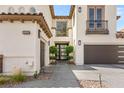 Close-up of a home's front entrance with a walkway leading to an ornate door and a two-car garage at 11453 Glowing Sunset Ln, Las Vegas, NV 89135