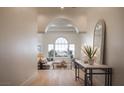 Bright, open-concept living room with arched doorway and modern decor at 1610 Brock Ct, Las Vegas, NV 89117