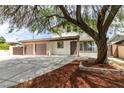 Charming two-story home featuring a two-car garage, mature landscaping, and inviting curb appeal at 1806 Renada Cir, North Las Vegas, NV 89030