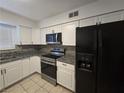 Bright kitchen features modern appliances, white cabinets, and granite countertops at 1806 Renada Cir, North Las Vegas, NV 89030
