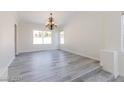 Bright living room with chandelier and light gray vinyl floors at 1904 Imola Ct, Las Vegas, NV 89123