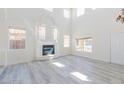 Two-story living room with fireplace and light gray vinyl floors at 1904 Imola Ct, Las Vegas, NV 89123