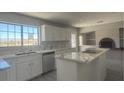 Modern kitchen featuring marble countertops, stainless steel appliances, and an island cooktop at 1967 N Moapa Valley Blvd, Logandale, NV 89021
