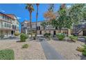 Community courtyard featuring desert landscaping, mature trees and walkways connecting buildings at 2080 Karen Ave # 12, Las Vegas, NV 89169