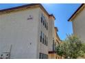 Condominium building with light stucco exterior, dark trim and desert landscaping at 2080 Karen Ave # 12, Las Vegas, NV 89169