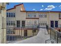 Two story condo buildings featuring walkways to units, balconies and manicured landscaping at 2080 Karen Ave # 12, Las Vegas, NV 89169