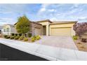 Lovely single-story home features a two-car garage, a stone facade, and a paved driveway at 2450 Amatrice St, Henderson, NV 89044