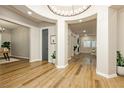 An elegant home entrance featuring wood flooring, circular lighting and archways to other rooms at 2450 Amatrice St, Henderson, NV 89044