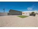 This backyard features gravel, a small patch of grass, a PODS moving container, and a view of the house at 2807 Hermosa St, Las Vegas, NV 89169