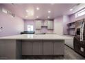 Well-lit, modern kitchen featuring an expansive center island and stainless steel appliances at 2807 Hermosa St, Las Vegas, NV 89169