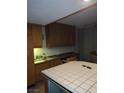 A kitchen featuring wooden cabinets and a white tiled kitchen island at 3111 Bel Air Dr # 6E, Las Vegas, NV 89109