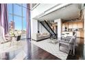 Open-concept living room featuring hardwood floors, floor-to-ceiling windows, and modern furnishings at 360 E Desert Inn Rd # 807, Las Vegas, NV 89109