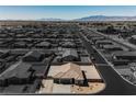 Aerial view of a single-story home in a residential neighborhood, with desert landscape at 37 Late Harvest Ave, Pahrump, NV 89060