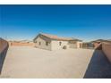 Desert landscape backyard with block wall and gated entry offering potential for customization at 37 Late Harvest Ave, Pahrump, NV 89060