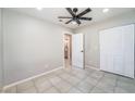 Cozy bedroom with tile flooring, closet space, and ceiling fan for added comfort at 4036 E Ogden Ave, Las Vegas, NV 89110