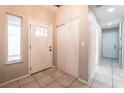Inviting entryway with tile flooring, a large storage closet, and a bright front door at 4036 E Ogden Ave, Las Vegas, NV 89110