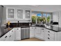 Bright kitchen with white cabinets, granite countertops, stainless steel appliances, and a large window at 4617 Mancilla St, Las Vegas, NV 89130