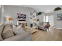 Open-concept living room with neutral decor and hardwood flooring at 4617 Mancilla St, Las Vegas, NV 89130