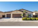 Charming single-story home with a three-car garage, well-maintained landscaping, and a welcoming curb appeal at 4937 Semifonte Dr, Pahrump, NV 89061