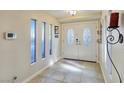 Bright entryway with tiled floors, decorative windows, and an ornate double door at 5159 N Monte Cristo Way, Las Vegas, NV 89149
