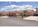 Beautiful single-story home with a three-car garage, desert landscaping, and a classic tile roof at 5441 Rose Hills St, Las Vegas, NV 89149