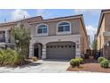 Two-story home featuring an attached two-car garage, small garden and gated entry at 5661 Brimstone Hill Ave, Las Vegas, NV 89141