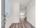 Bright foyer with wood floors and a view of the open living and dining areas at 5661 Brimstone Hill Ave, Las Vegas, NV 89141