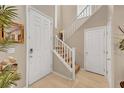 Welcoming foyer with staircase, tile flooring, and neutral paint at 5854 Willow Trace Ave, Las Vegas, NV 89139