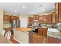 Well-equipped kitchen with stainless steel appliances and butcher block island at 6049 Paddleboat St, North Las Vegas, NV 89031