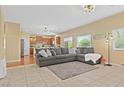 Spacious living room with tile floors and view to kitchen at 6049 Paddleboat St, North Las Vegas, NV 89031
