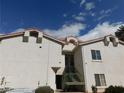 Exterior view of townhome with a red tiled roof and stairwell with green iron railings at 6201 E Lake Mead Blvd # 218, Las Vegas, NV 89156