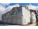 Exterior townhome with a three-car garage and balcony, showcasing classic architectural design at 6201 E Lake Mead Blvd # 218, Las Vegas, NV 89156