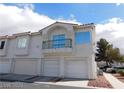 Exterior townhome with a three-car garage and balcony, showcasing classic architectural design at 6201 E Lake Mead Blvd # 218, Las Vegas, NV 89156
