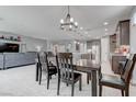 Bright dining area with modern lighting fixtures, flowing into an open-concept living space at 6985 Hopi Summit Ct, Las Vegas, NV 89149