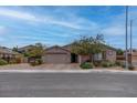 Charming single-story home with a well-maintained front yard and a two-car garage at 6985 Hopi Summit Ct, Las Vegas, NV 89149