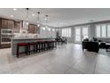 Open-concept kitchen featuring a large island with seating and stainless steel appliances at 6985 Hopi Summit Ct, Las Vegas, NV 89149