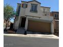 Inviting two-story home with a private balcony, and a convenient two-car garage at 7484 Butterton Ct, Las Vegas, NV 89139