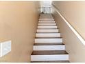 Bright stairway with a white banister and painted white and brown treads at 7553 Durham Hall Ave # 201, Las Vegas, NV 89130