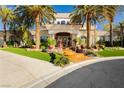 Inviting entrance with lush lawn, vibrant flower pots, and an elegant doorway featuring wrought iron detailing at 7625 Coley Ave, Las Vegas, NV 89117
