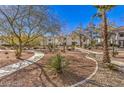 Beautifully landscaped grounds with walking paths and mature trees at 7912 Foxwood Pl # 104, Las Vegas, NV 89145