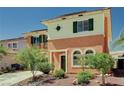 Charming two-story home showcasing green shutters and lush landscaping at 7920 Aviano Pines Ave, Las Vegas, NV 89129