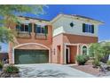 Charming two-story home showcasing a green garage door, shutters and lush landscaping at 7920 Aviano Pines Ave, Las Vegas, NV 89129