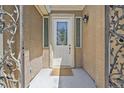Inviting front door with decorative glass and wrought iron accents at 7986 Merlewood Ave, Las Vegas, NV 89117