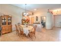 Traditional dining room with tile flooring, chandelier lighting, and decorative furnishings creating a welcoming atmosphere at 8089 Black Orchid Ave, Las Vegas, NV 89131
