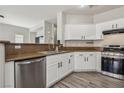 Modern kitchen featuring stainless steel appliances, granite countertops, and sleek white cabinetry at 914 Appaloosa Hills Ave, North Las Vegas, NV 89081