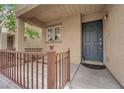 Inviting front porch features a cozy space with railings, complemented by the home's exterior at 9141 Careful Canvas Ave, Las Vegas, NV 89149
