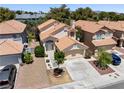 Charming home boasts a tile roof, well-manicured landscaping, and a two-car garage at 9520 Rancho Palmas Dr, Las Vegas, NV 89117